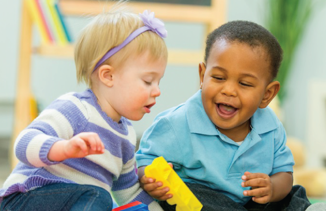 Toddlers playing with toys on display