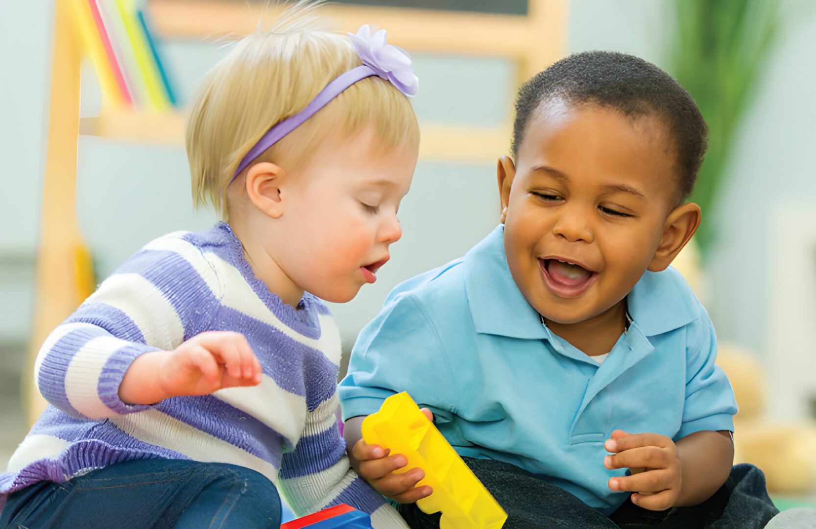 Kids sharing colorful building blocks
