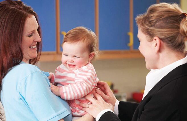 Women playing with laughing baby
