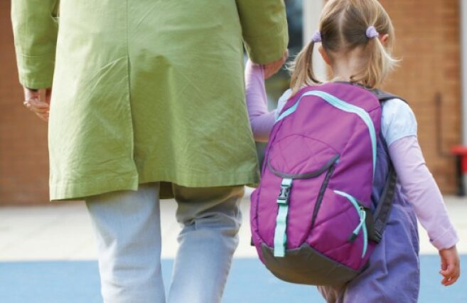 Little girl and adult walking together