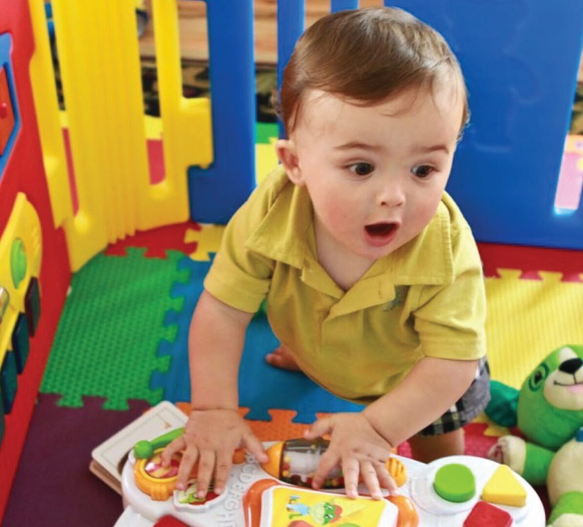 Toddler playing with colorful toy blocks
